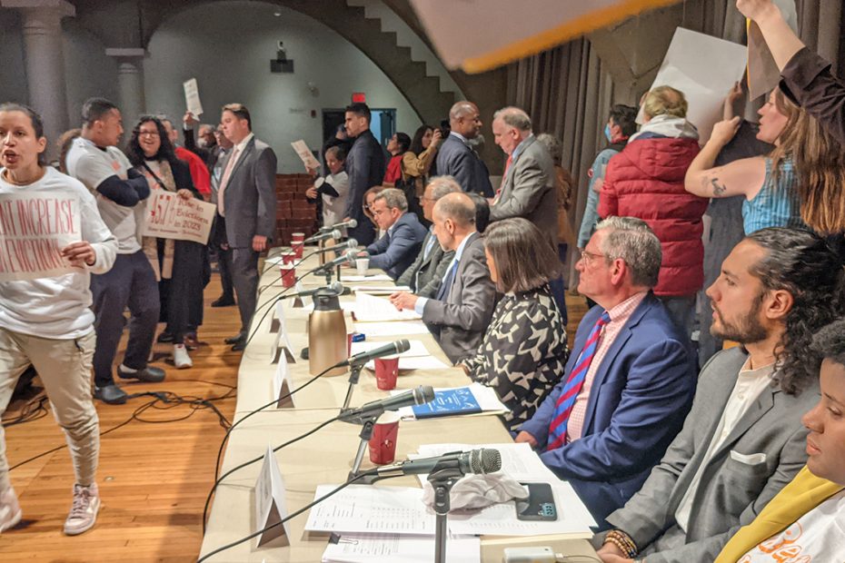 a panel on affordable housing with protesters present